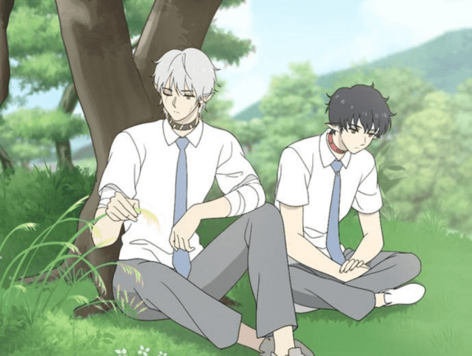 Haru and hook sitting in the green grass beneath a tree, vibing